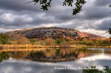Enchanted Rock reflected in Moss Lake.