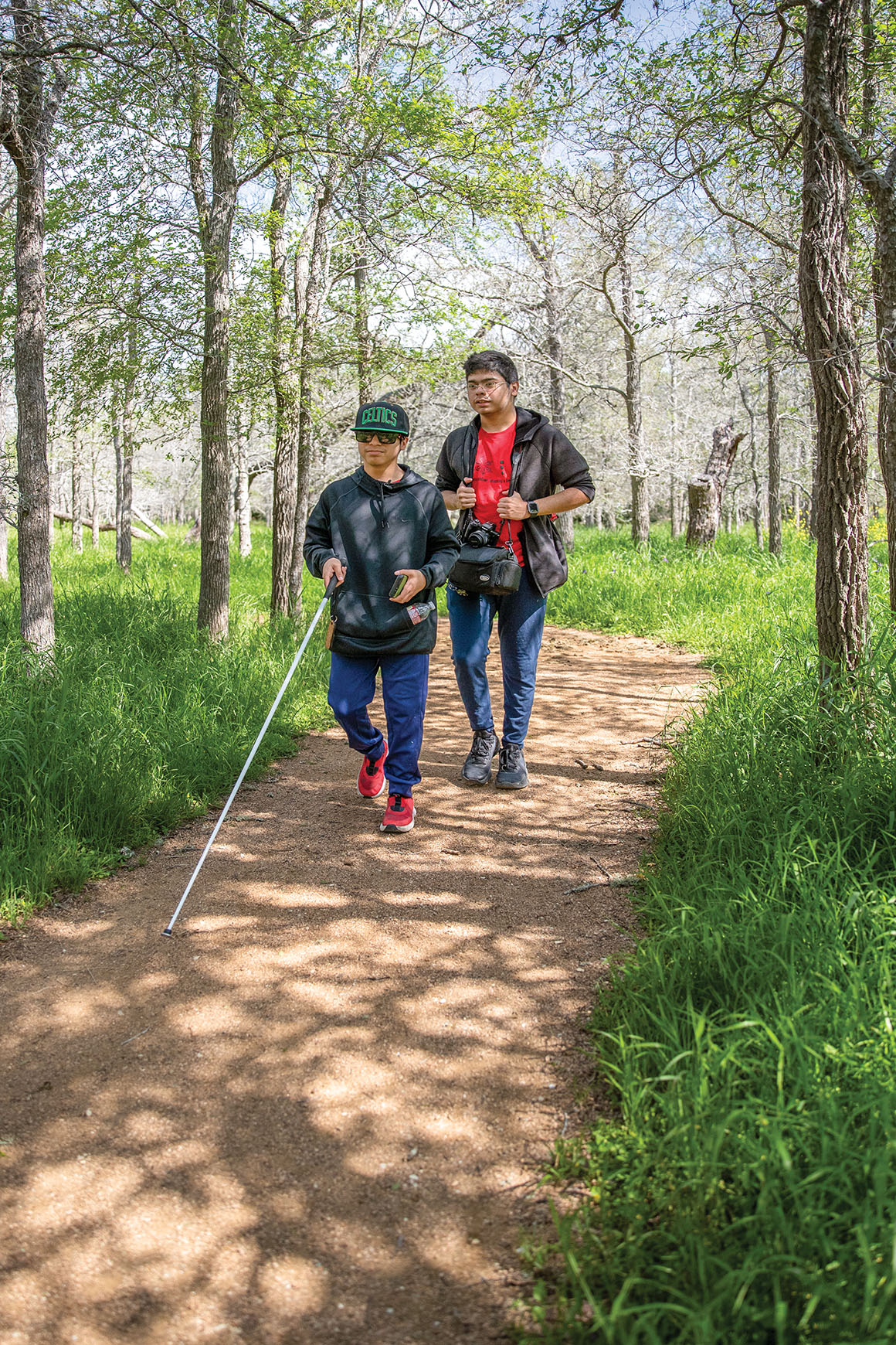 Two blind campers hike along a state park trail