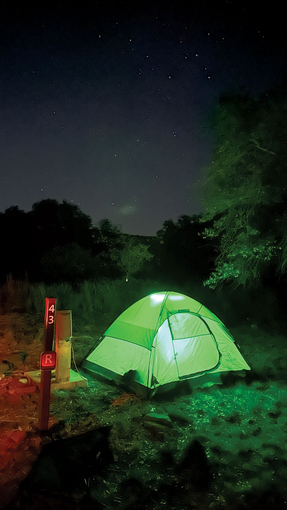 Illuminated tent under dark skies
