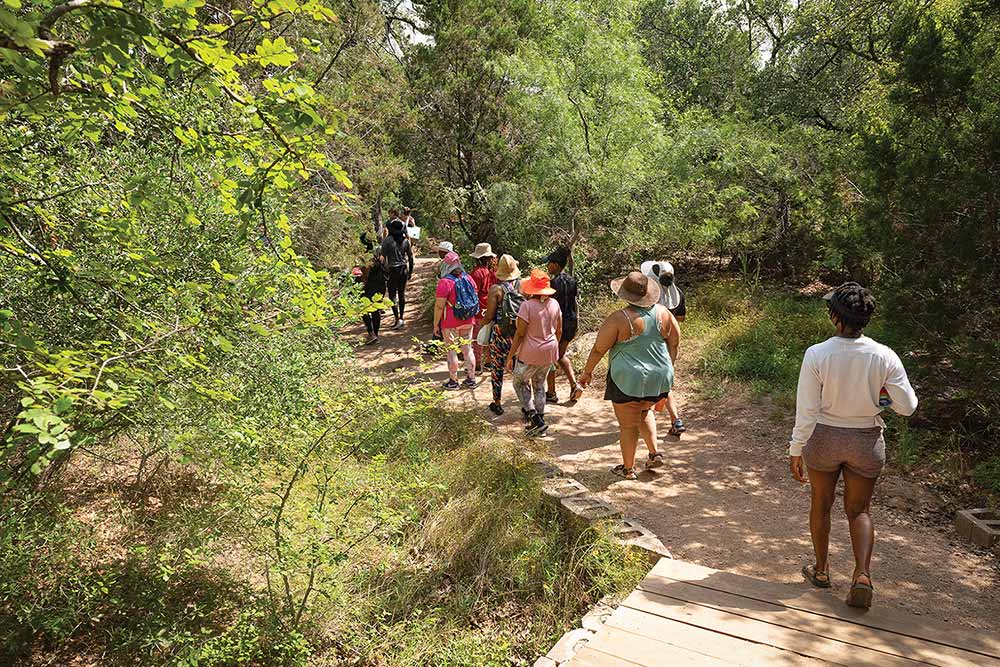 Black Women Who hiking trhu the woods