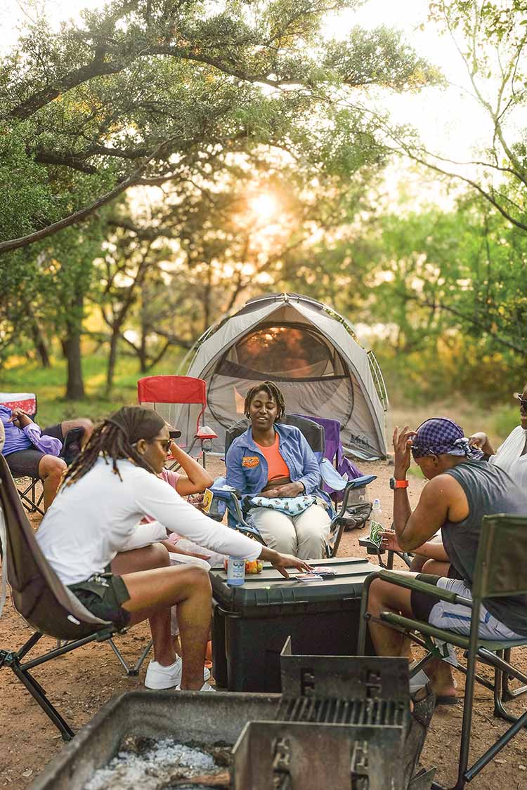 Black Women Who playing cards at campsite