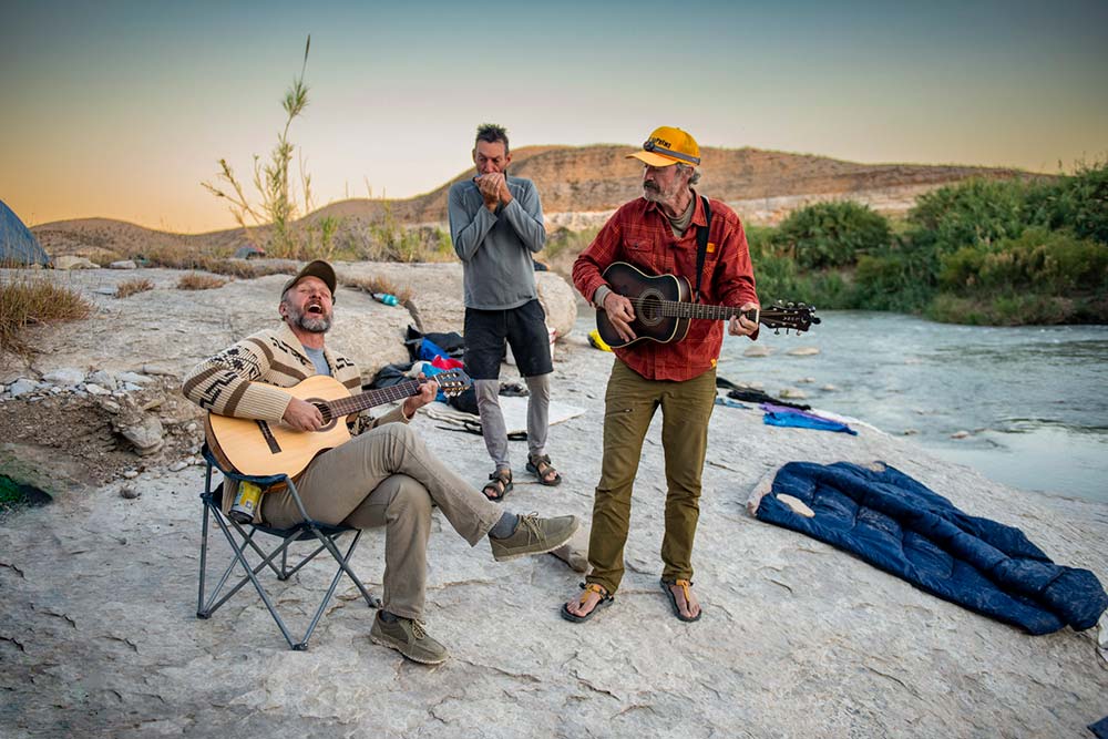 group of men singing and playing music