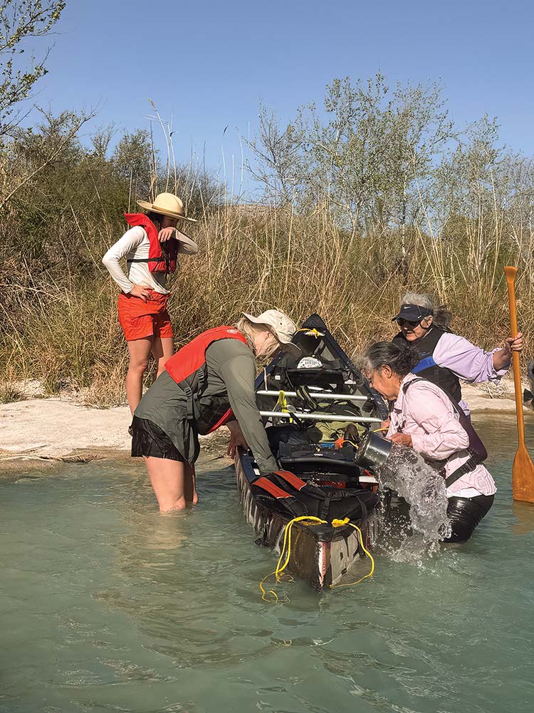 paddlers bail water from canoe
