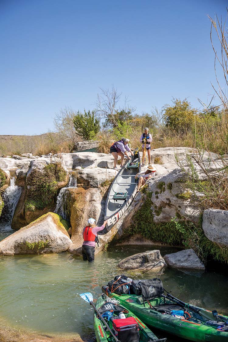 paddlers lift canoes and kayaks out of water