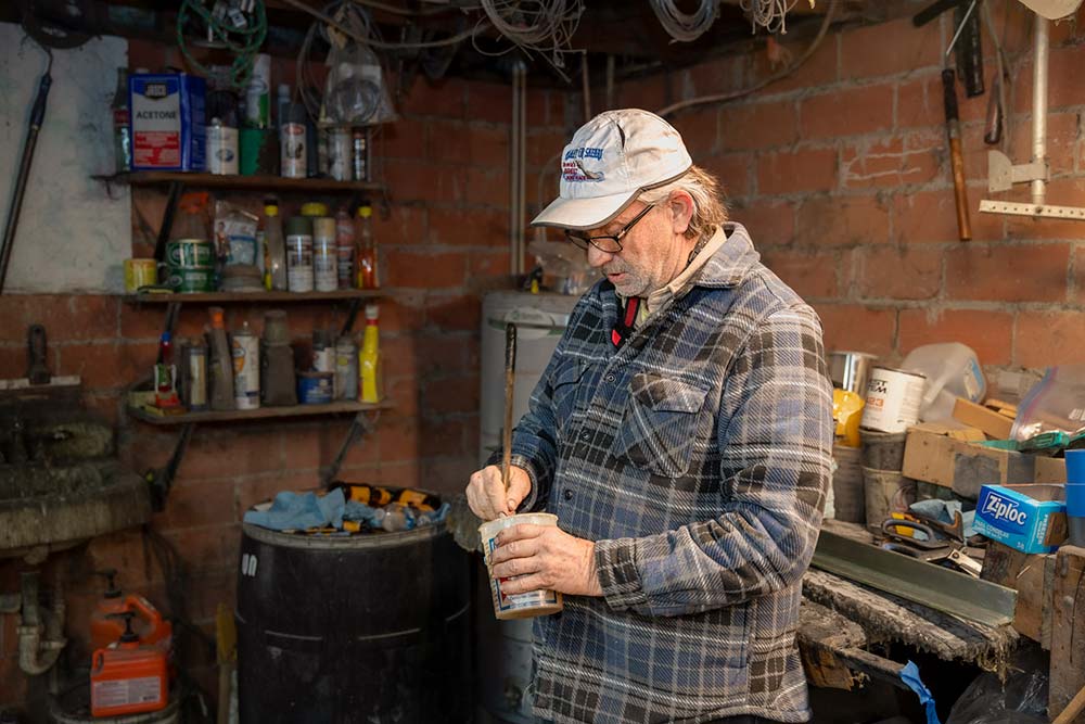 Spencer mixes resin to patch one of his boats
