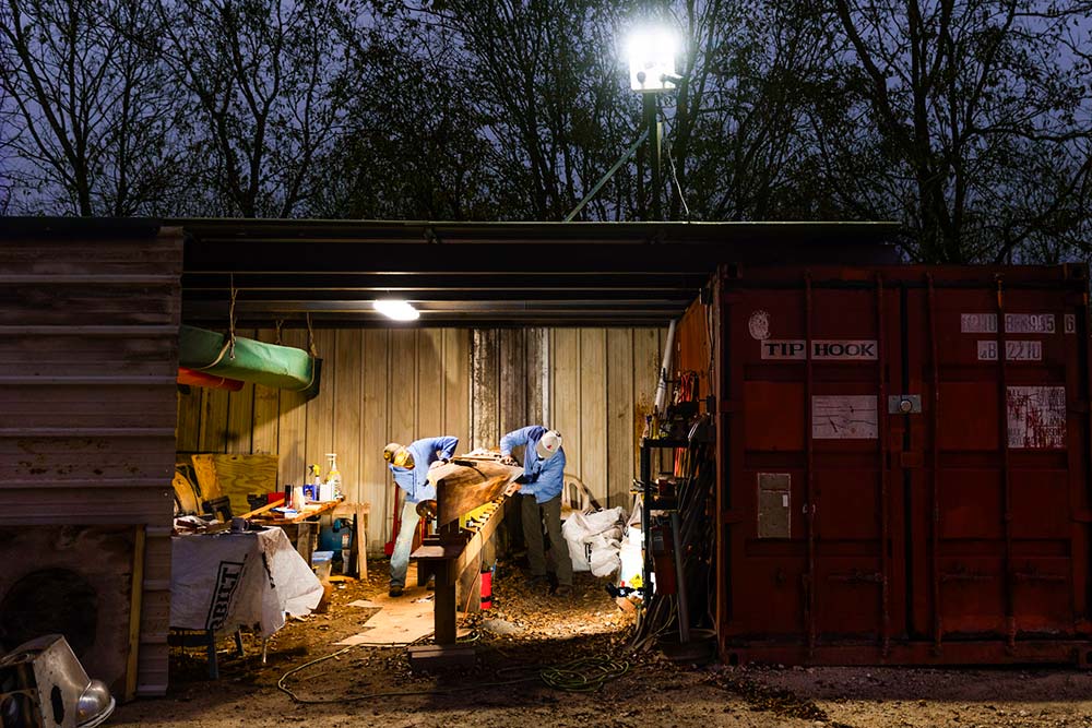 Gaston Jones and Safari veteran Jeff Glock work on a racing canoe in Glock's Travis County shed.