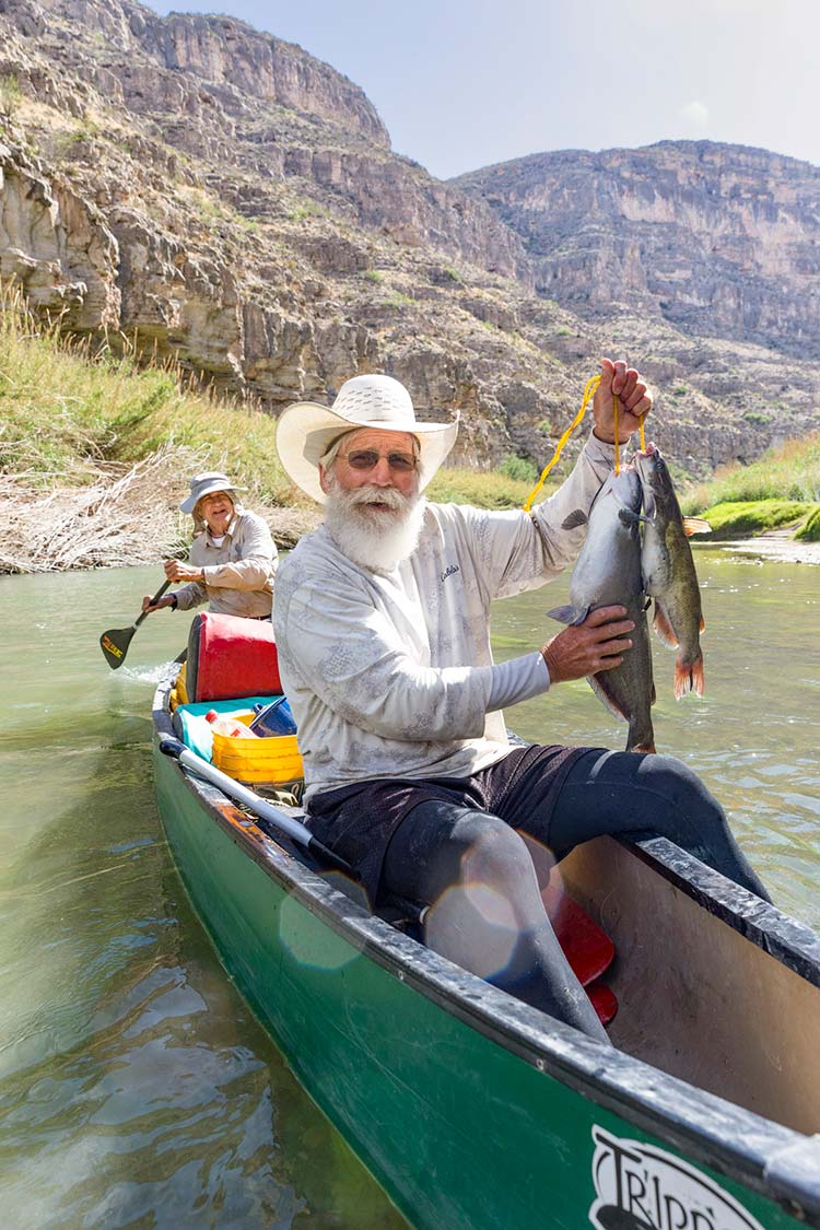 Bill “Polecat” Stafford holds two nice catfish he caught on juglines.