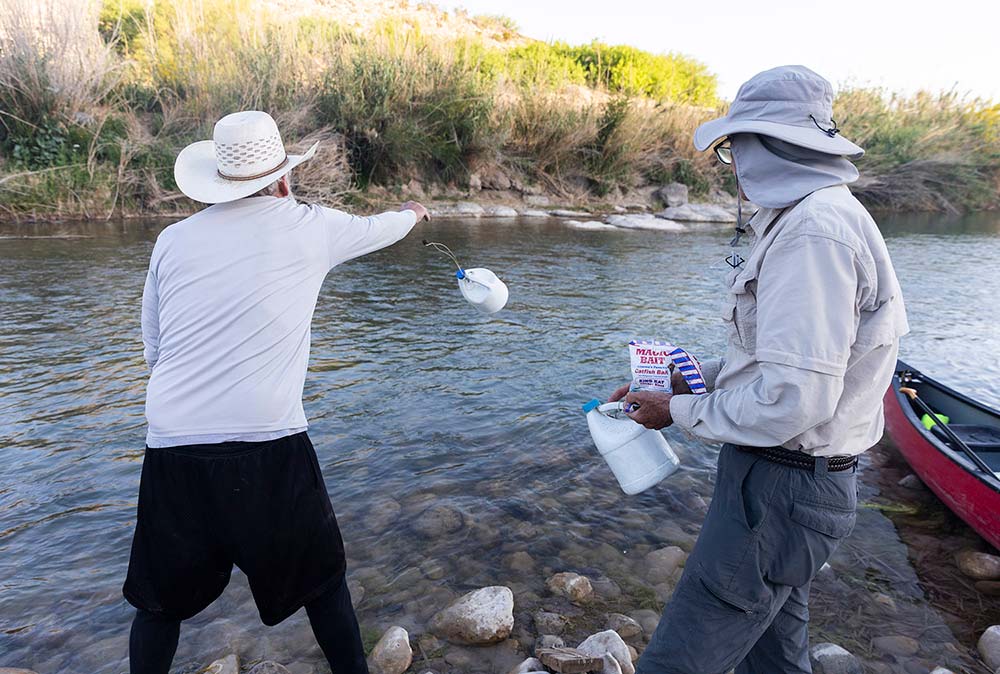 Stafford prepares several jugs with line and baited hooks.