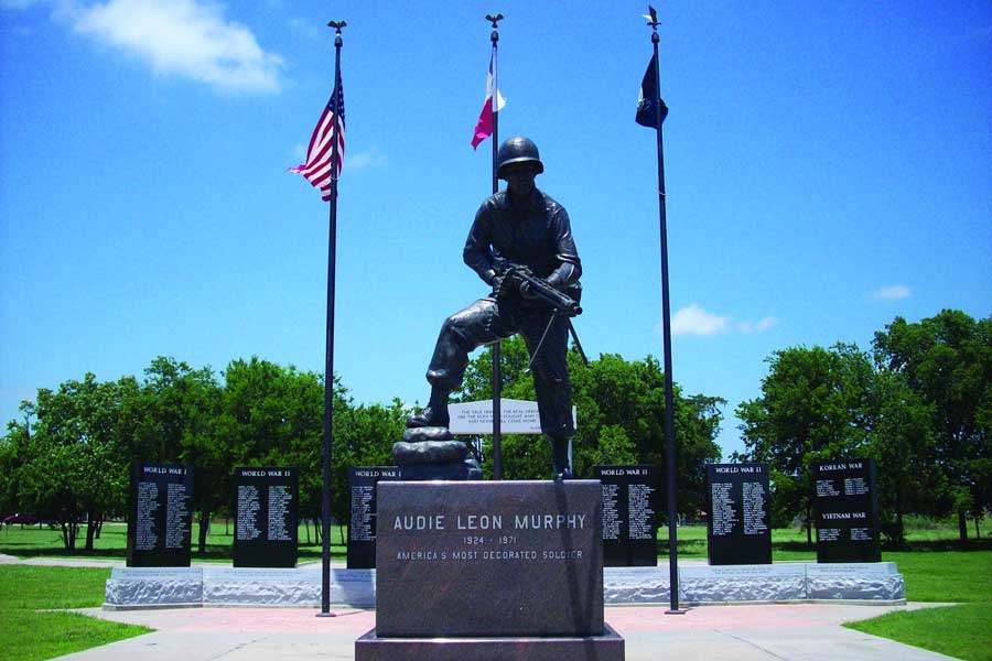 Statue of Audie Murphy with Flags in background