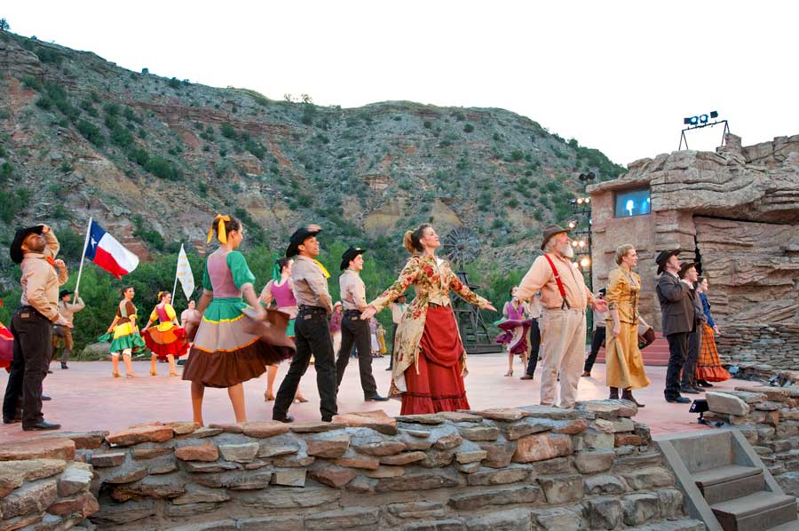 Actors perform on stage in the Texas Outdoor Musical