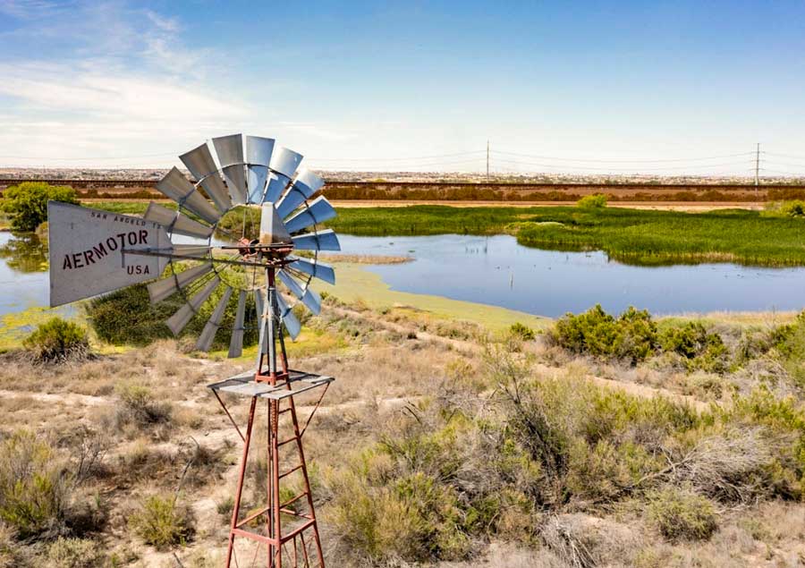 Windmill stands tall over the water and trails of Rio Bosque Wetlands Park