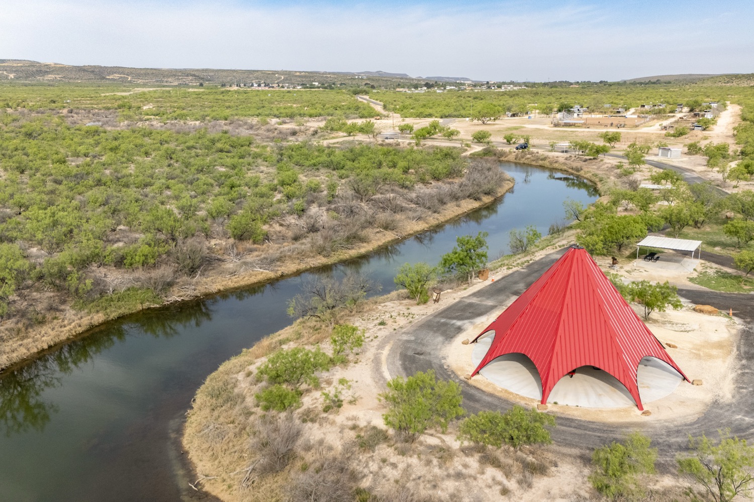 Aerial view of Pecos River and park with red teepee