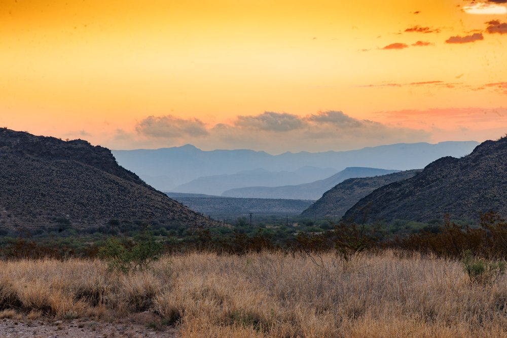 Picture of hills and grassland taken at sunset.