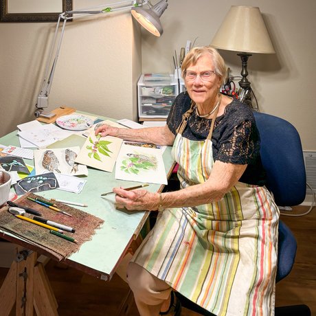 Nancy Pruitt sits at her drawing desk.