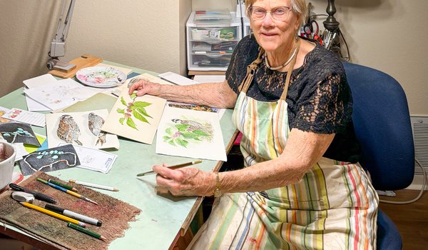 Nancy Pruitt sits at her drawing desk.