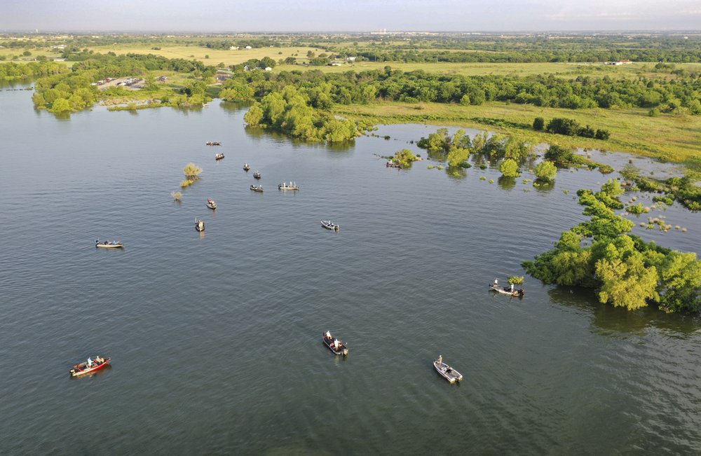 Many bass fishing boats on a lake