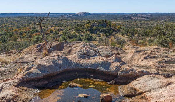 A puddle of water surrounded by rocks at an overlook