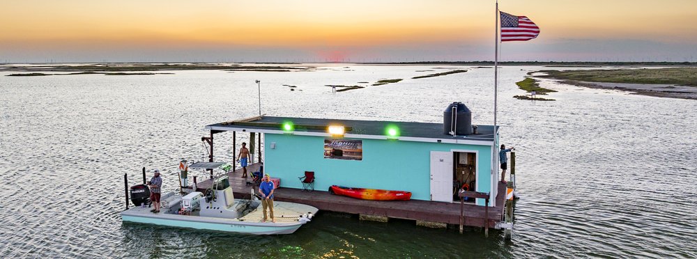 An overhead view of the floating cabin with a docked boat.