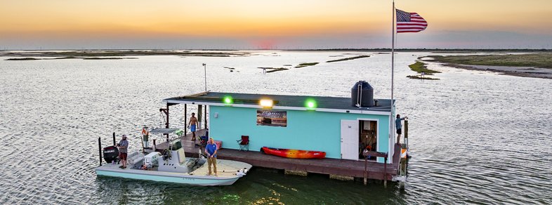 An overhead view of the floating cabin with a docked boat.