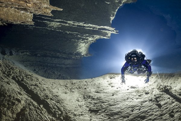 Person scuba diving in an underwater cave.