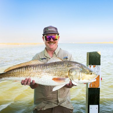 Person showing a large fish that they caught.