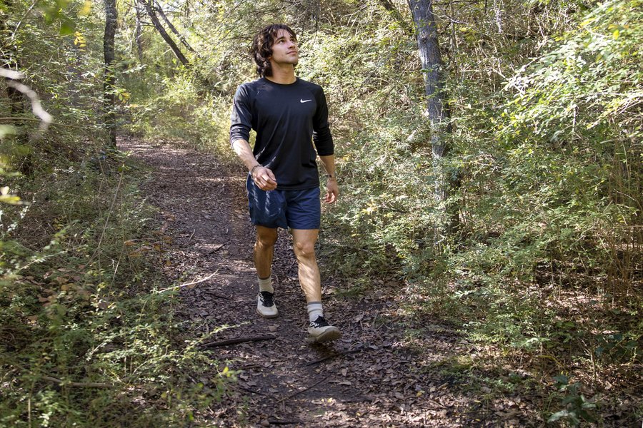 A person walking White Tail Hollow Trail at Cleburne State Park