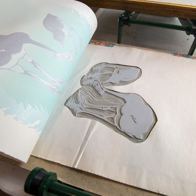 Paper being removed from a printing block.