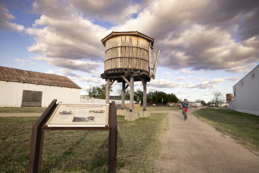 Water tower and interpretive sign at lake Mineral Wells State Trailway