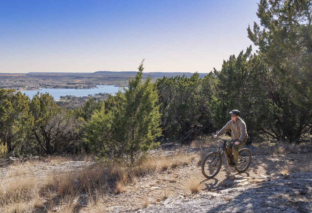 Person biking on the Possum Kingdom Hike and Bike Trail.