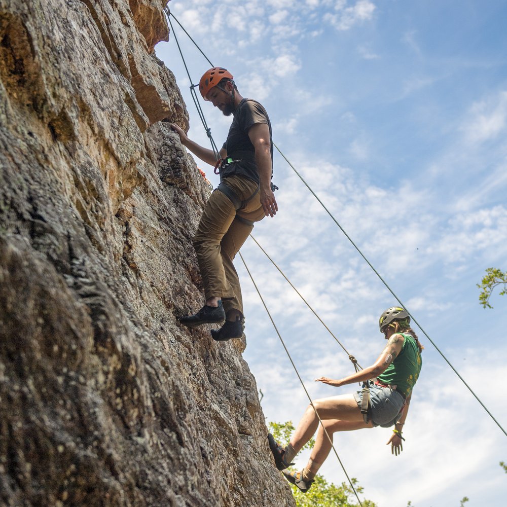 People rock climbing.