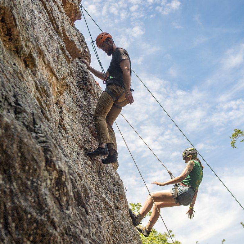 People rock climbing.