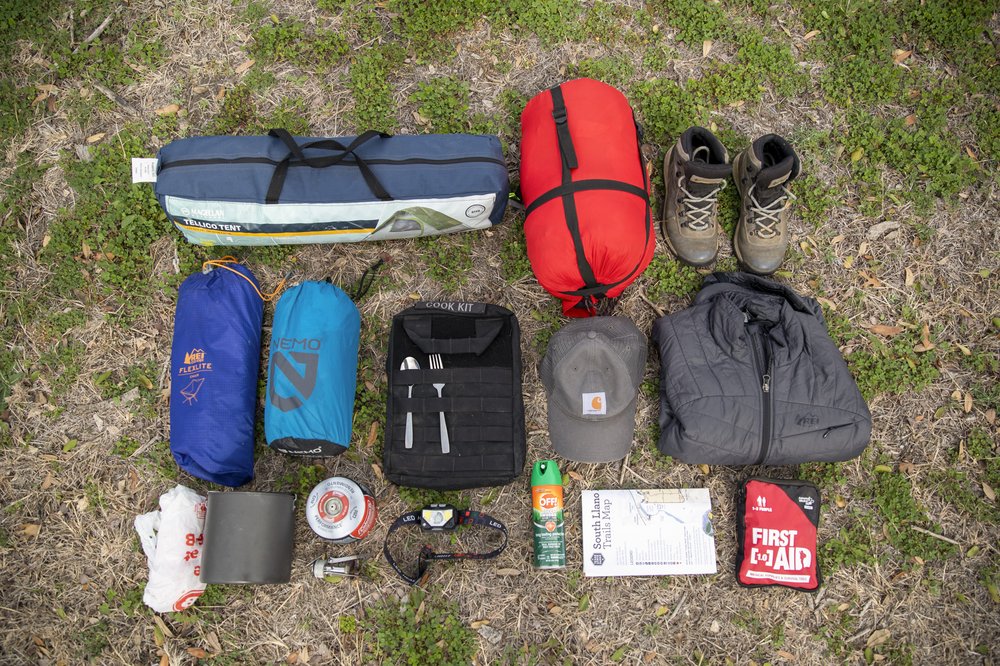 Camping gear laid out on the ground