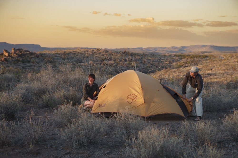 Two people set up a tent in Big Bend Ranch
