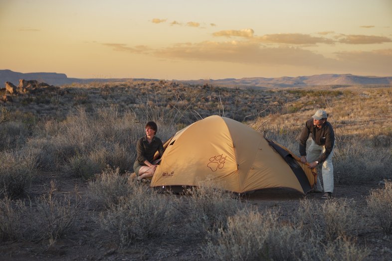 Two people set up a tent in Big Bend Ranch