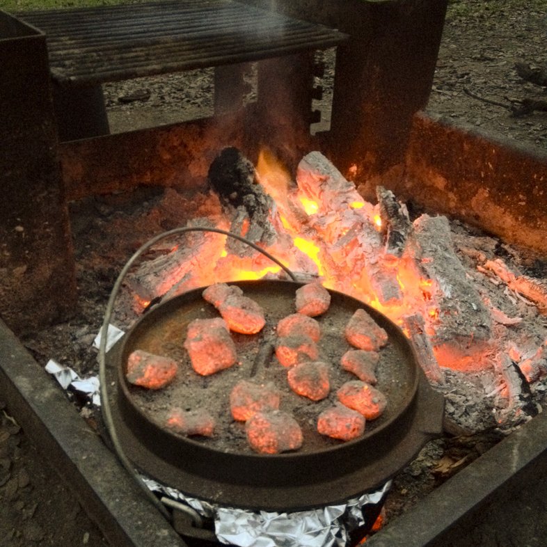 An outdoor grill with hot coals
