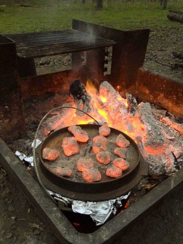 An outdoor grill with hot coals