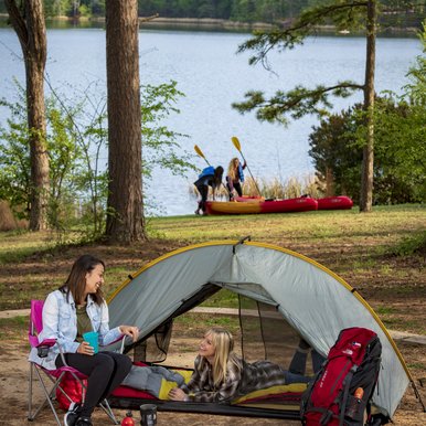 Two female Gen Z campers hanging out at a Tyler State Park