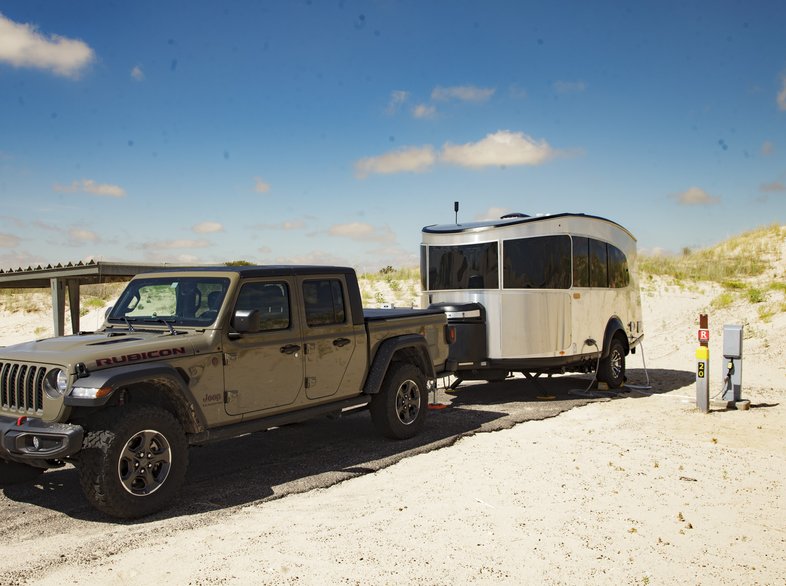 A truck with camper at a campsite