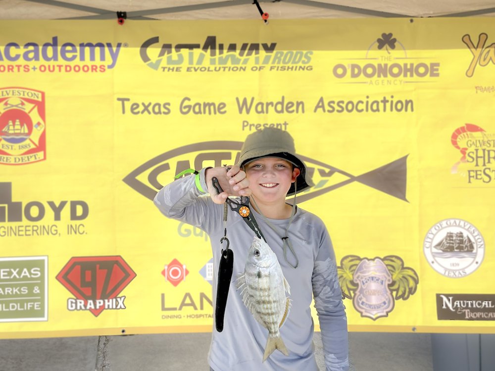 A young person shows off a fish