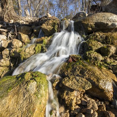 A small stream flows over rocks