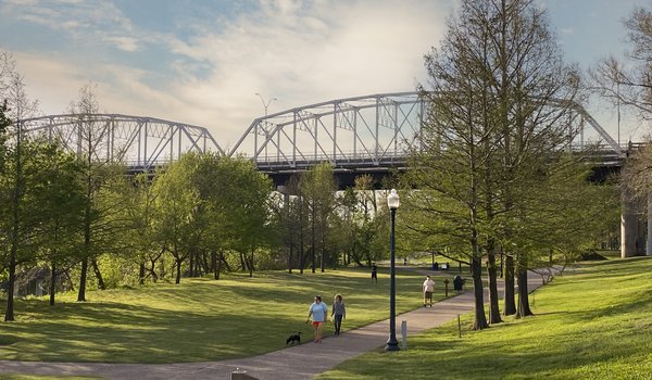 A view Old Iron Bridge on the Colorado River seen from the June Hill Pape Riverwalk trail in Bastrop