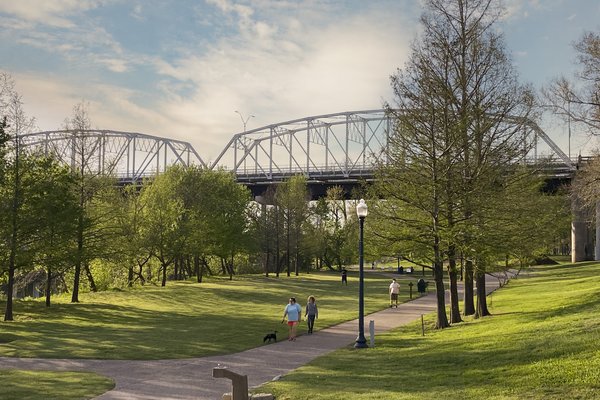 A view Old Iron Bridge on the Colorado River seen from the June Hill Pape Riverwalk trail in Bastrop