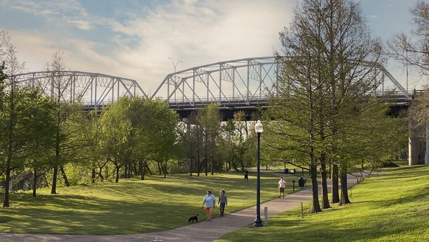 A view Old Iron Bridge on the Colorado River seen from the June Hill Pape Riverwalk trail in Bastrop