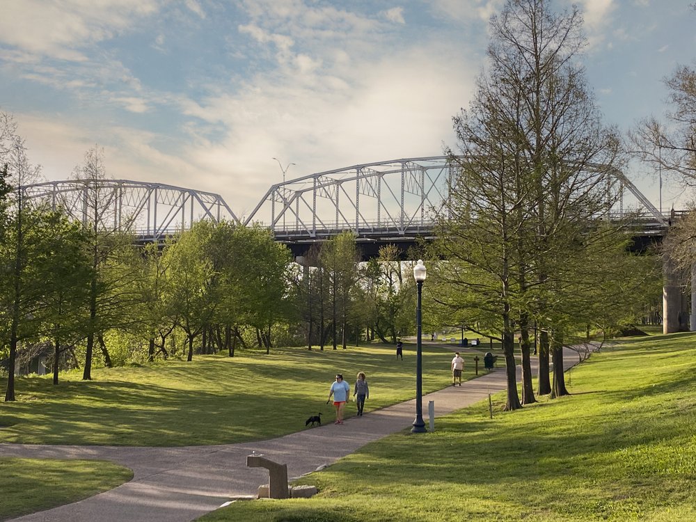 A view Old Iron Bridge on the Colorado River seen from the June Hill Pape Riverwalk trail in Bastrop