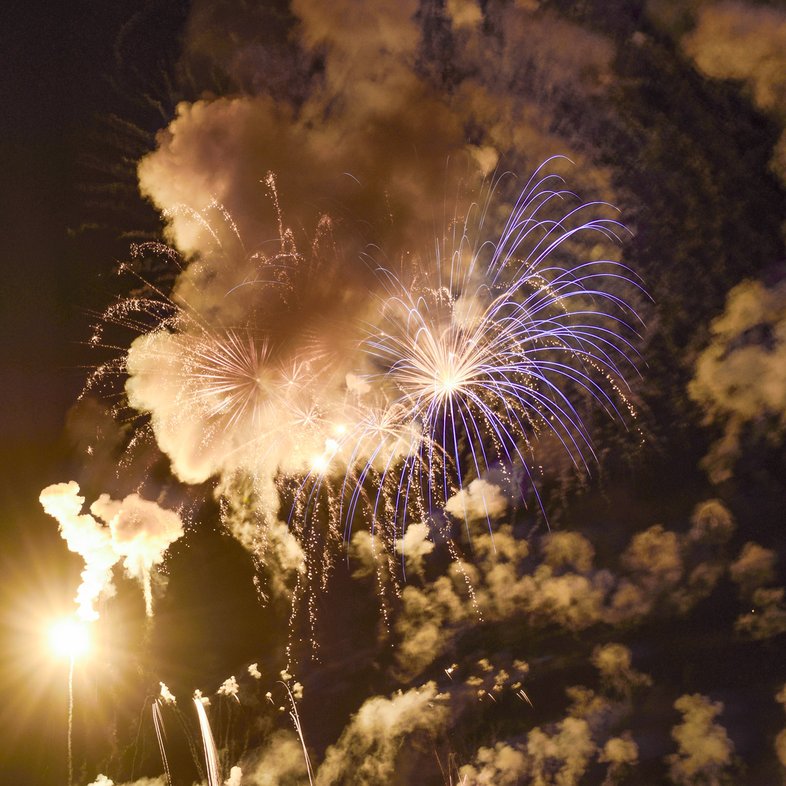 Fireworks shoot up in to the sky over the lake