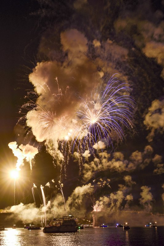 Fireworks shoot up in to the sky over the lake