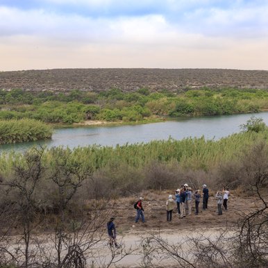 A group of people look through binoculars