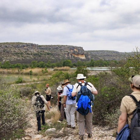 A group of people are hiking on a trail