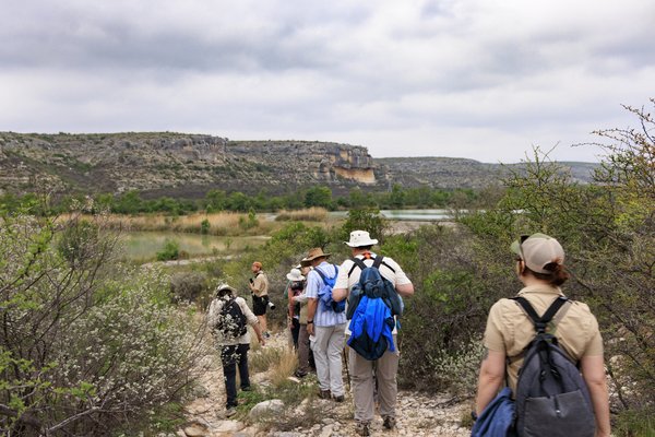 A group of people are hiking on a trail