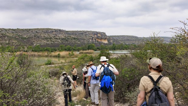 A group of people are hiking on a trail